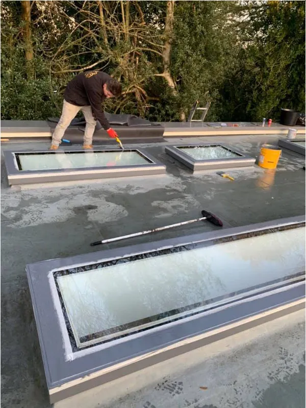 Goldhawk roofer finishing a new flat roof around two rooflights