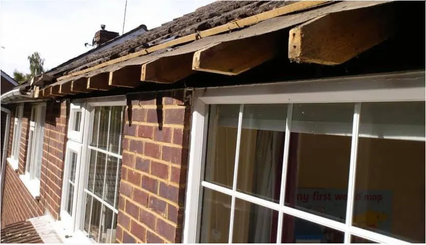Before: bungalow eaves with rotten timber boards removed, then new white UPVC fascias fitted