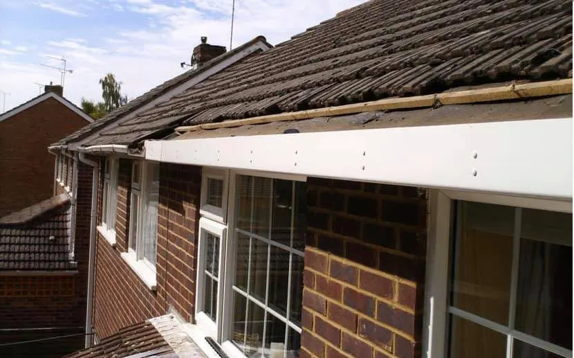 bungalow eaves with rotten timber boards removed, then new white UPVC fascias fitted