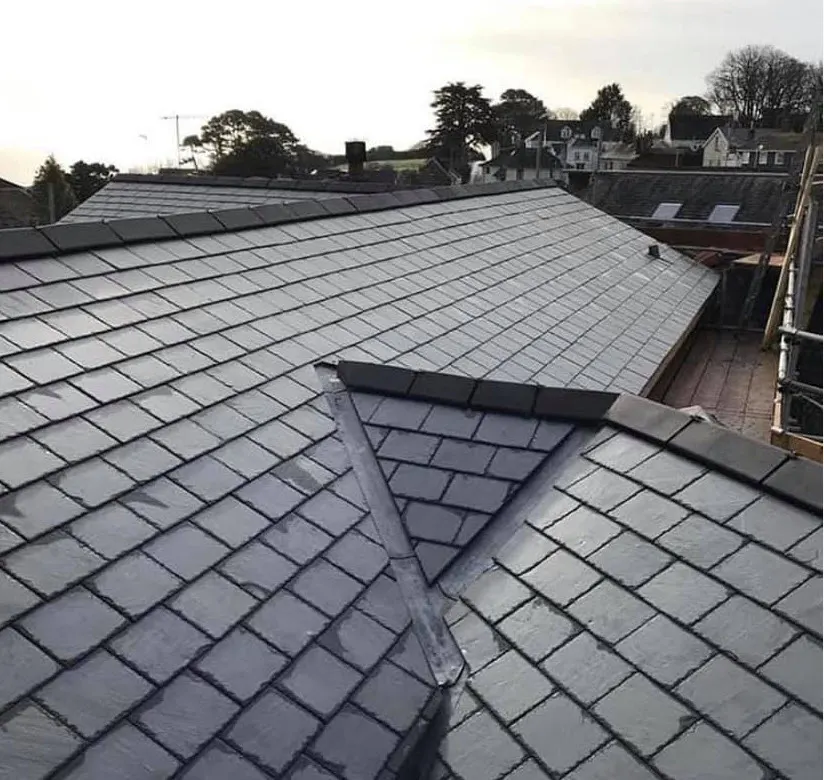 Finished natural slate roof with a slate-lined valley where two roof slopes meet