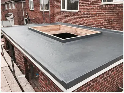 New grey flat roof with a timber upstand formed for a rooflight