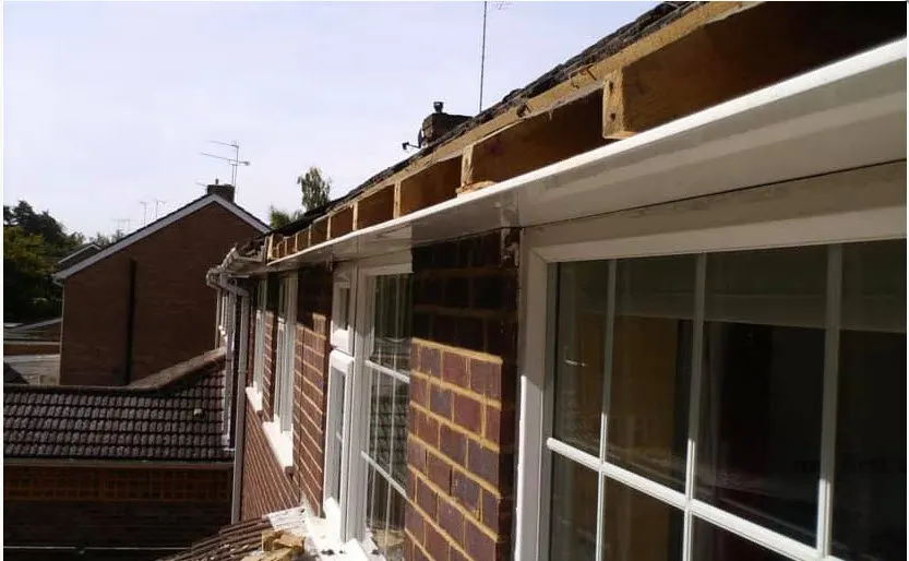White UPVC soffit and gutter fitted along the eaves with the rafter ends still exposed further along